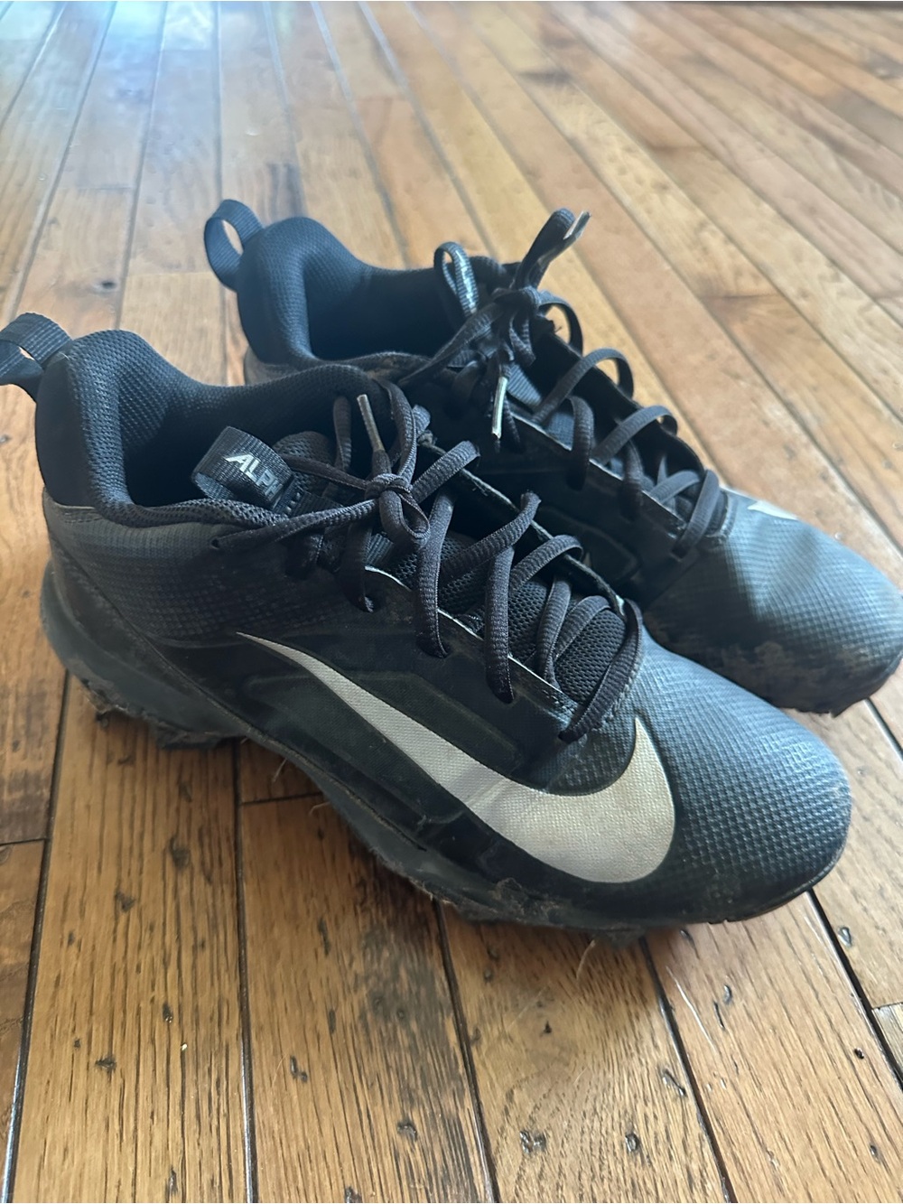 Nike Youth Black Athletic Cleats with White Swoosh